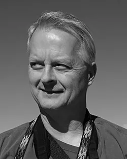 black and white photo of a man smiling