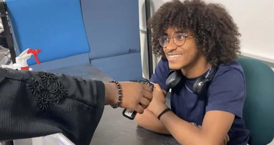 male smiling being interviewed at a desk