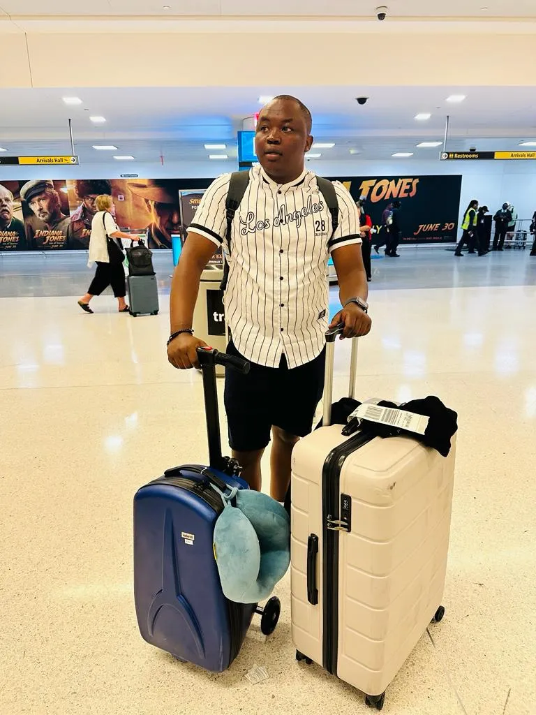 photo of NHCC student, Donald Agik, at JFK airport, with his luggage going to Amsterdam 