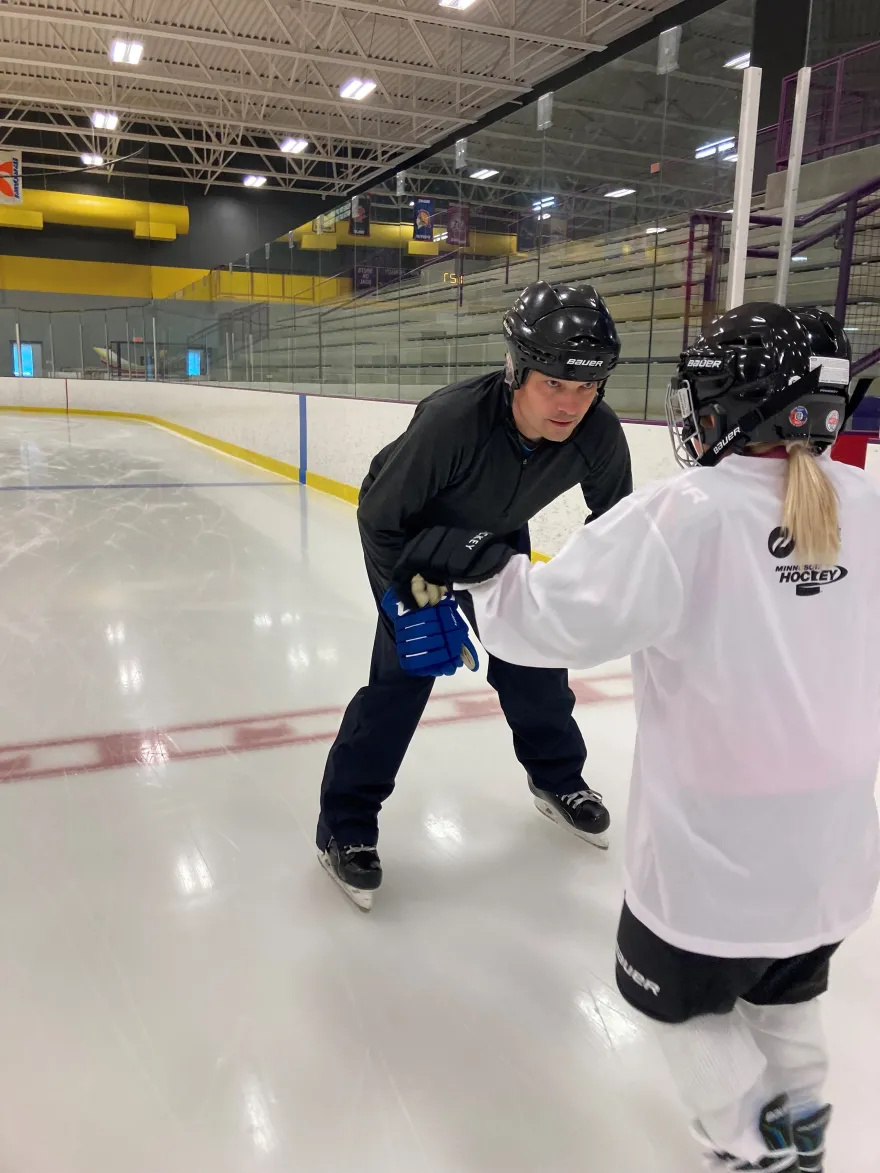 Derrick Lindstrom teaches his niece how to ice skate