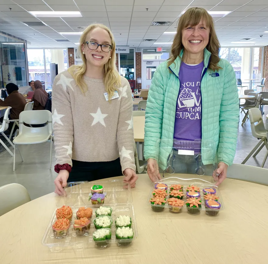 photo of NHCC employees Sara and Deane, with Deane's cupcakes