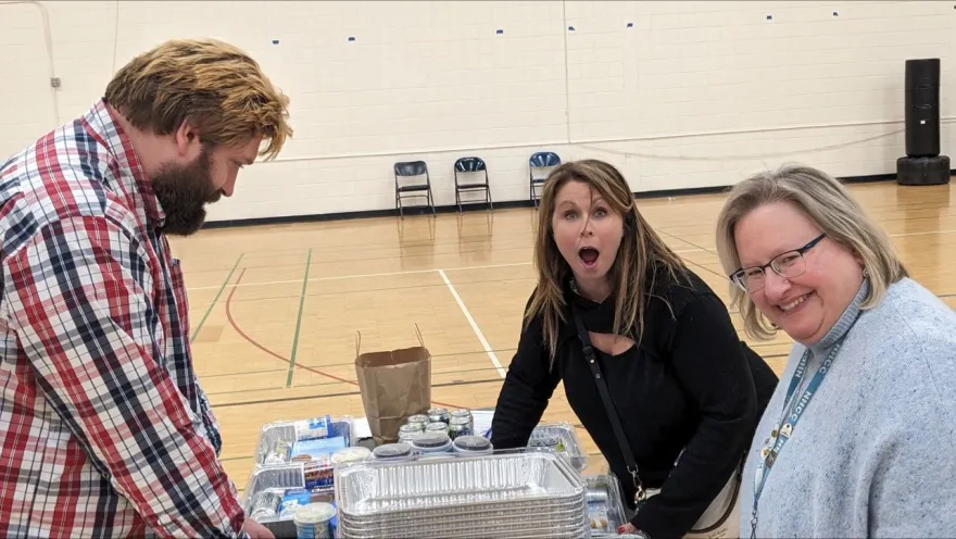 NHCC Employees smile at Guided Learning Pathways Day while volunteering to make Hygiene Kits