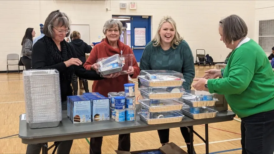 NHCC Employees smile at Guided Learning Pathways Day while volunteering to make Hygiene Kits