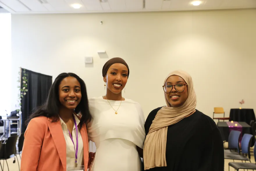 students smiling with guest speaker