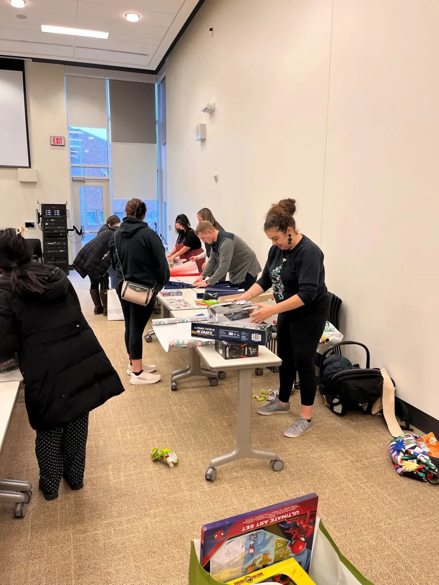 volunteers wrapping gifts at the toy drive