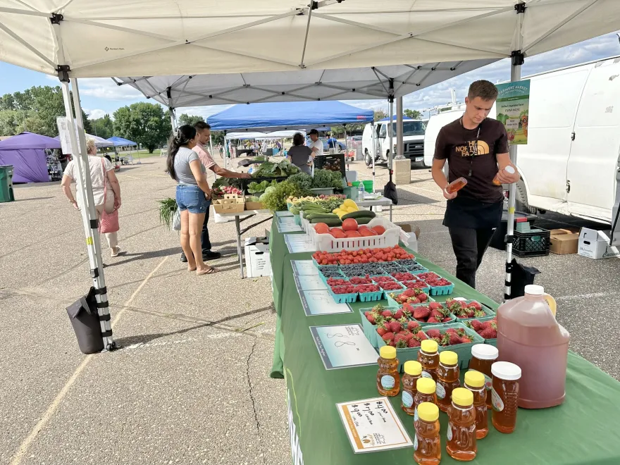 a photo of a table of produce at the Farmers Market in our parking lot outside