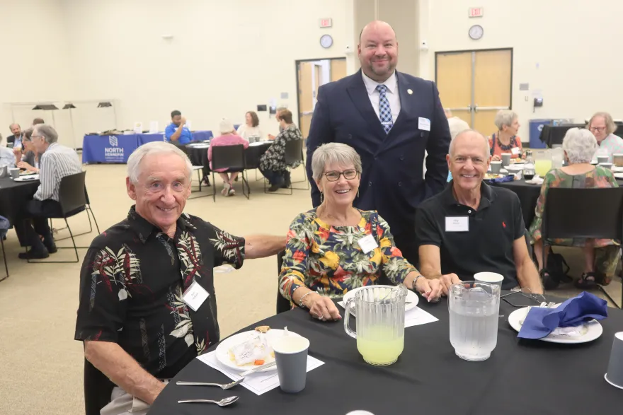 a photo of prominent NHCC figures, smiling at the Retiree Luncheon 