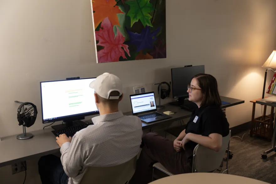 two people working at a computer 