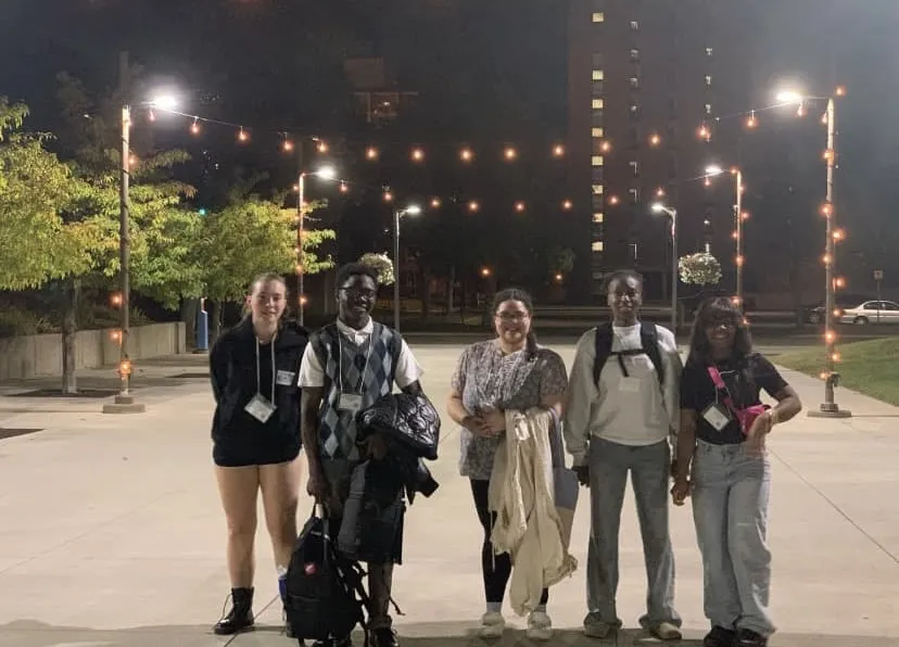 a group of NHCC students smiling for the camera outside while in St. Cloud for a PTK conference. 