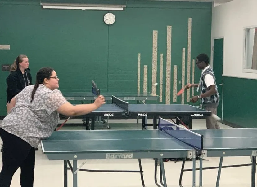 a photo of three PTK students playing ping pong on the St. Cloud campus. 