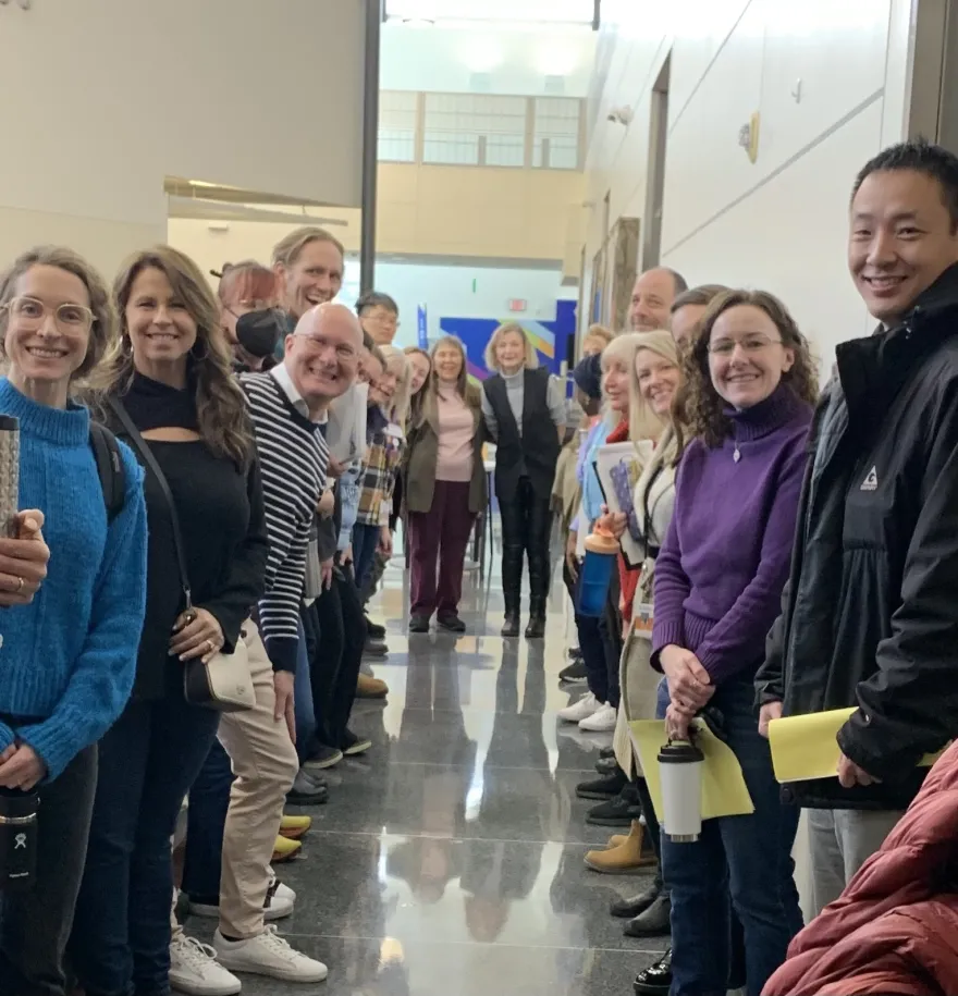 a group photo of NHCC faculty smiling at Duty Day in the CBT building on-campus in January of 2025. 