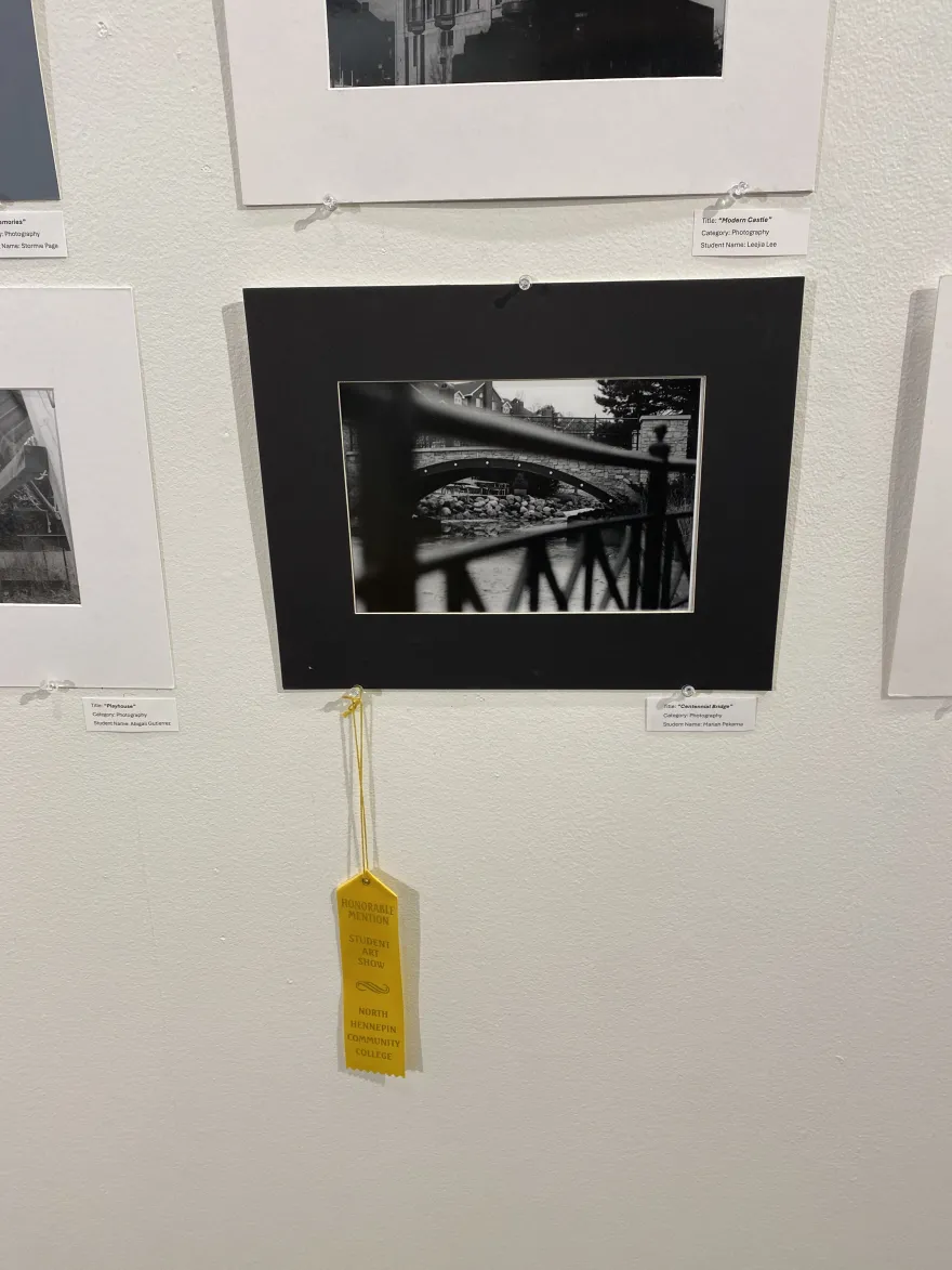 This is a photo of a photographic piece that received an Honorable Mention award at the NHCC Student Art Show, titled, “Centennial Bridge.” 