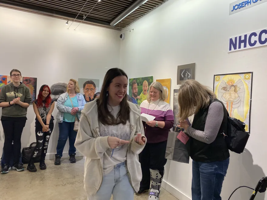 This is a photo of NHCC student, Elizabeth Nelson receiving an award at the 2025 Student Art Show. 
