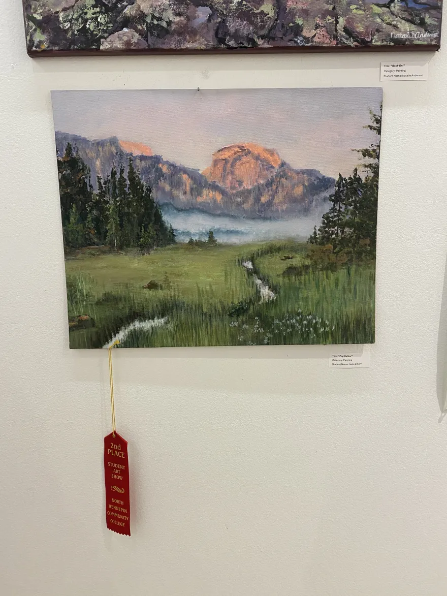 This is a photo of a painting that received an award ribbon at the NHCC Student Art Show, titled, “Fog Valley.”