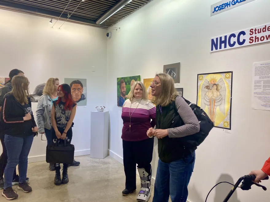 this is a photo of students congregating in the NHCC Art Gallery. 