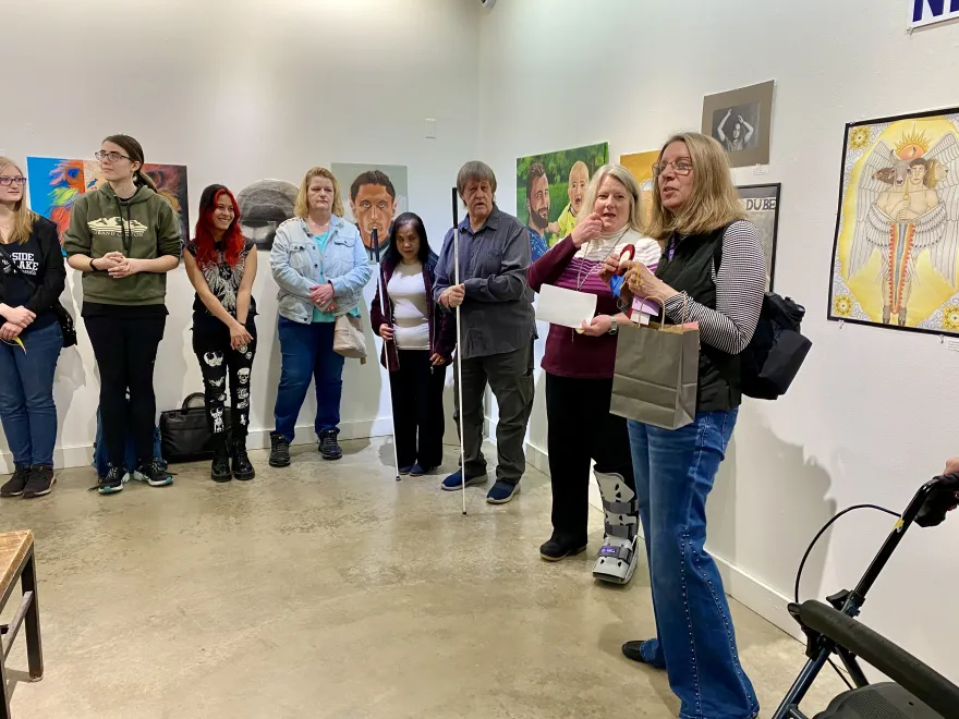 this is a photo of NHCC faculty Gina Dabrowski speaking to the crowd at the Student Art Show Awards Reception. 