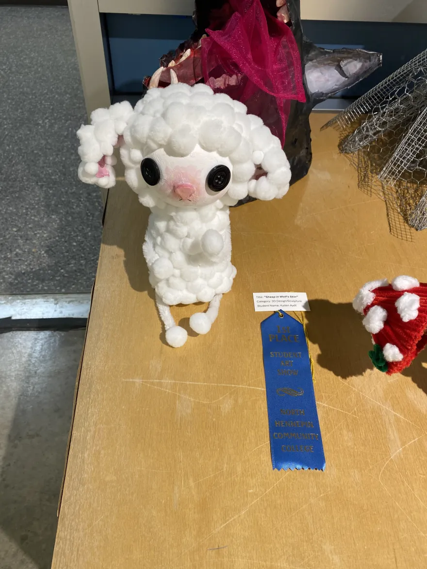 This is a photo of a sculpture that received a first-place award at the NHCC Student Art Show, titled, “Sheep in Wolf’s Skin.” 