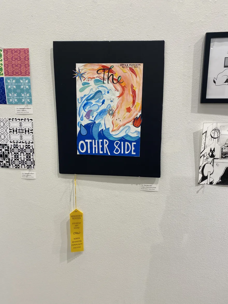 This is a photo of a mixed media piece that received an award ribbon at the NHCC Student Art Show, titled, “The Other Side.”