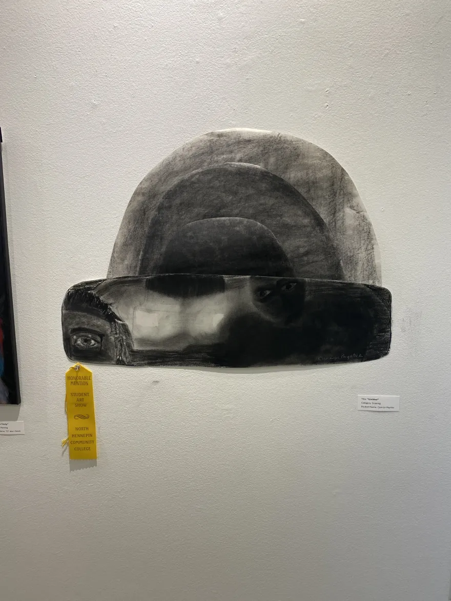 This is a photo of NHCC student, Camryn Paynter’s untitled drawing, with its Honorable Mention ribbon.  