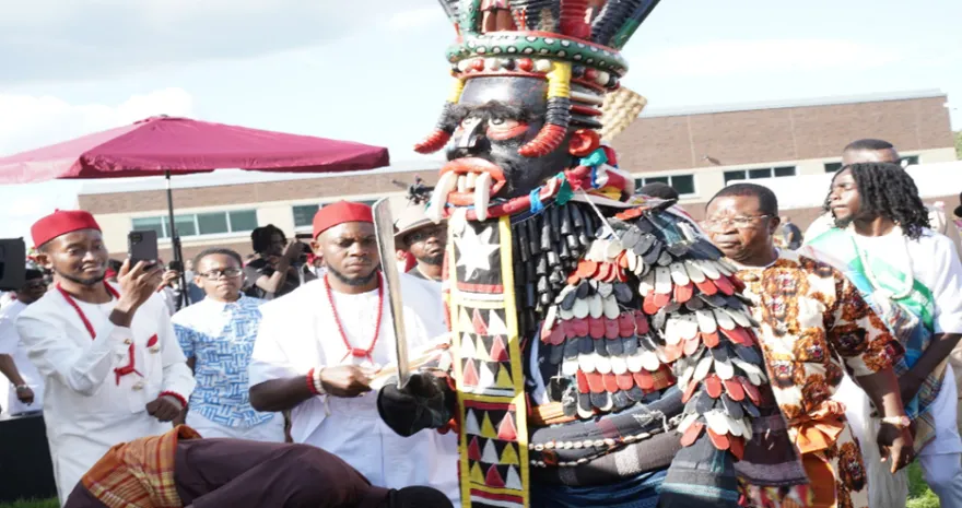 This is a photo of a group of African men, at a cultural IgboFest event, dressed in regalia, celebrating the event. 