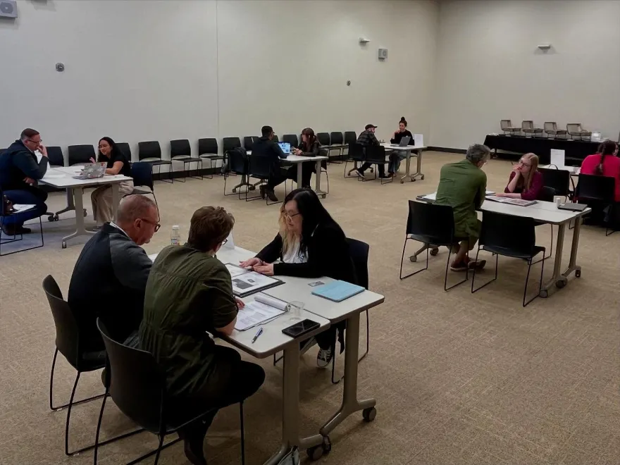 this is a photo of NHCC students sitting at tables with employers being interviewed on-campus during our annual Xperience Project Internship Fair.