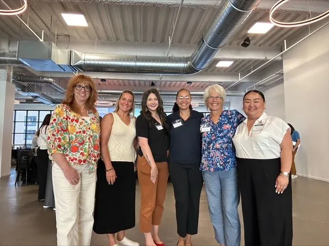 this is a group photo of smiling NHCC staff and faculty taken at a summer externship continuing education/local career partnerships event. 