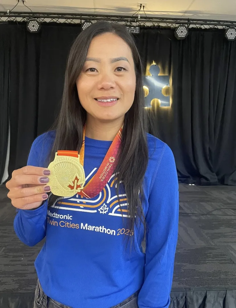 this is a photo of NHCC Guided Pathways Advisor, Anong Thor with her medal after completing the Twin Cities Marathon. 