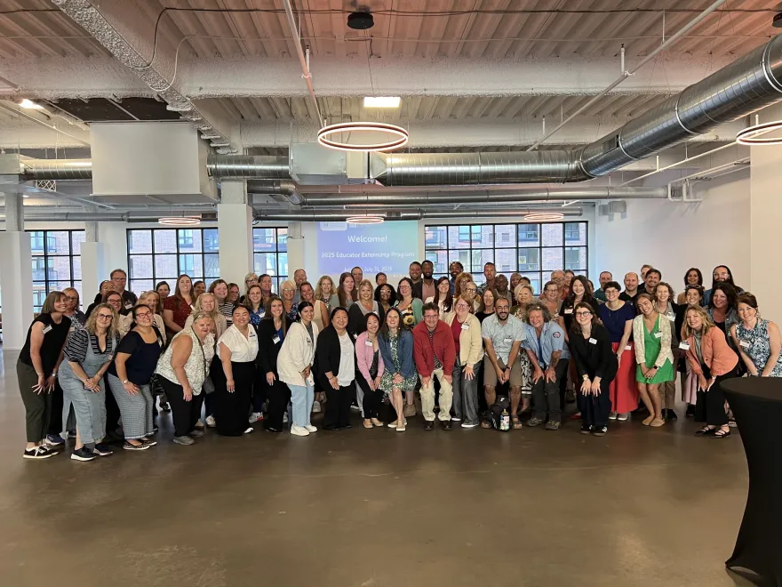 this is a very large group photo of a bunch of local educators and professionals standing at an off campus location with a few NHCC faculty and staff members over the summer of 2025 at an externship career education event. 