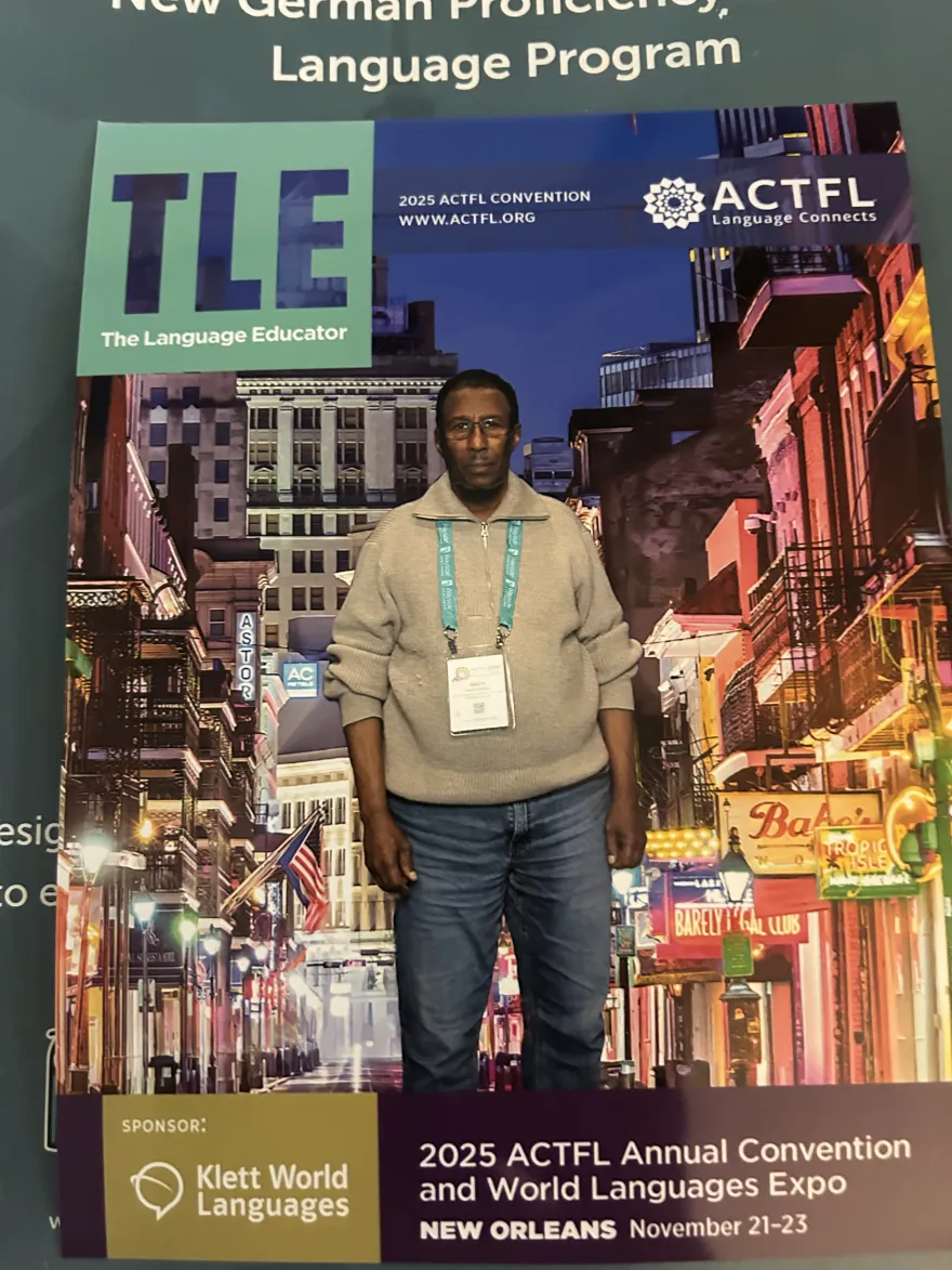 This is a photo of NHCC Arabic faculty member, Dr. Sidow Mohammed on the cover of the 2025 American Council for The Teaching of Foreign Languages (ACTFL) annual conference program. 