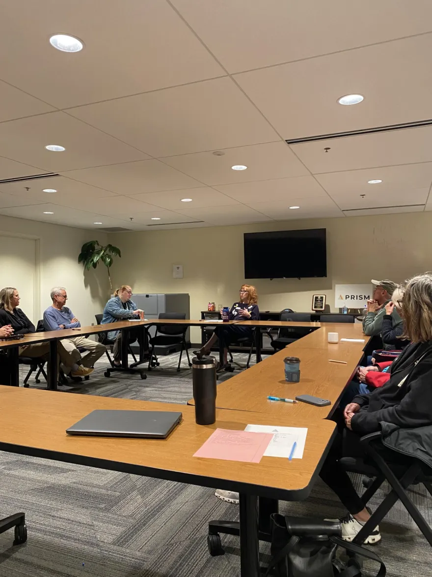 this is a photo of NHCC faculty, Amy Harms Hoad presenting to a room of attendees on Human Services topics at PRISM in Golden Valley.