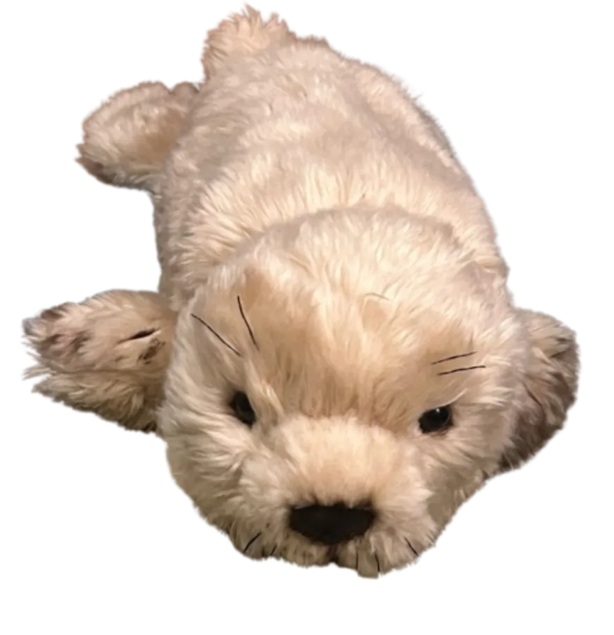 this is a photograph of a white, toy stuffed animal seal. It is part of a creative arts submission from an NHCC student.  