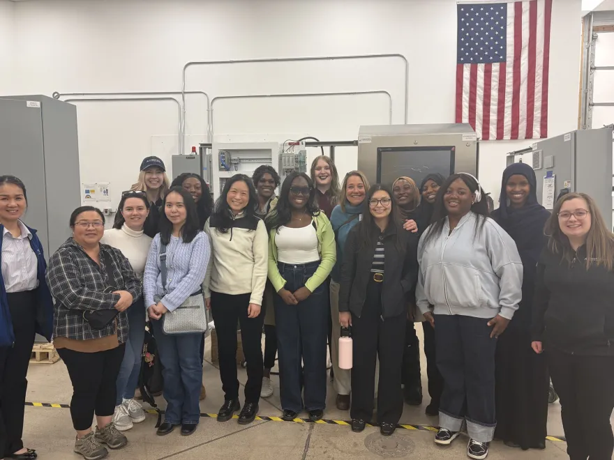 this is a group photo of a bunch of NHCC Be Bold female students on a tour of Cybertrol a local engineering firm, with three female engineers in the photo and NHCC staff, Maria Vittone. 