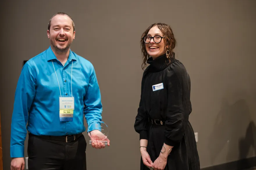 this is a photo of NHCC Student Life Director, Monte Stewart, being presented an award from Angela, the Communications Director at LeadMN. 