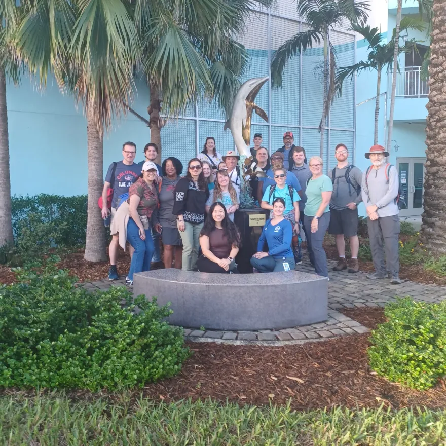 this is a group photo of business professor, Belinda Armstead in Florida, smiling with a big group of other people at a recent educational conference.