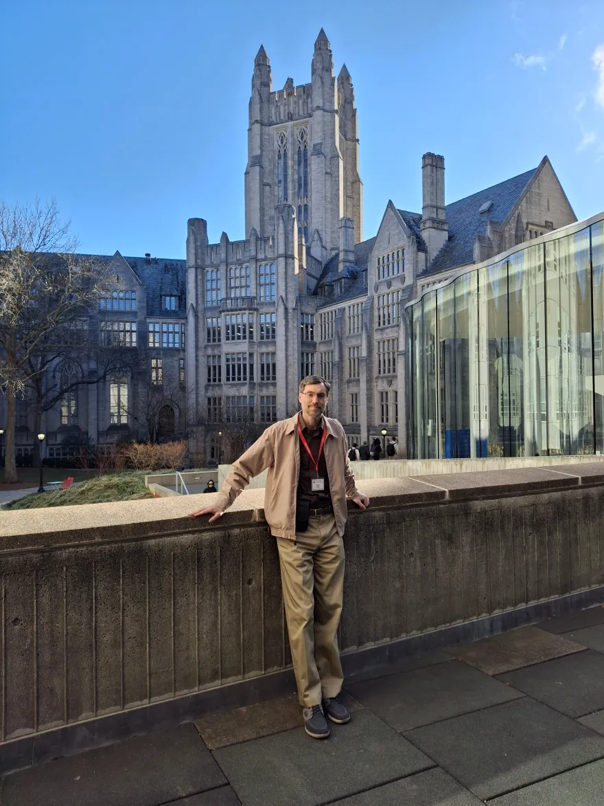 this is a photo of NHCC computer science professor, Jack Pope, standing with a stunning building behind him, while on campus at Yale University. 