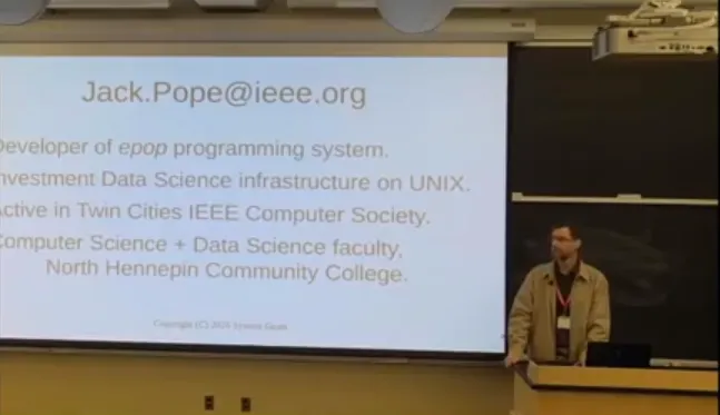 this is a photo of NHCC faculty, Jack Pope presenting next to a screen at Yale University. The screen reads, 'Jack.Pope@ieee.org Developer of epop programming system. Investment Data Science infrastructure on UNIX. Active in Twin Cities IEEE Computer Society. Computer Science + Data Science faculty, North Hennepin Community College.
