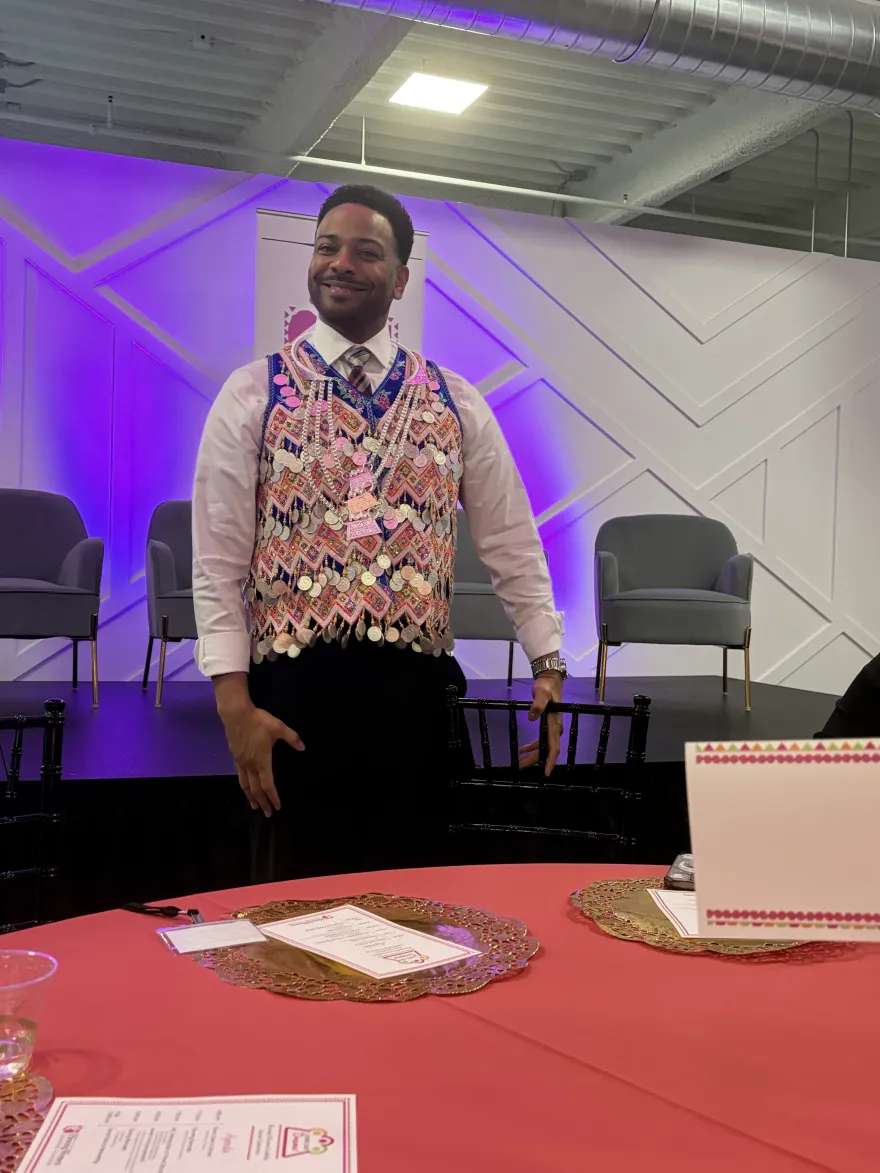 this is a photo of NHCC VP of Student Affairs, Julio Vargas-Essex wearing a traditional Hmong money vest. 