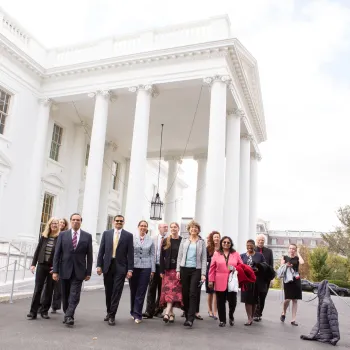 gathering of people including Dr. Eugenia Paulus standing outside white house