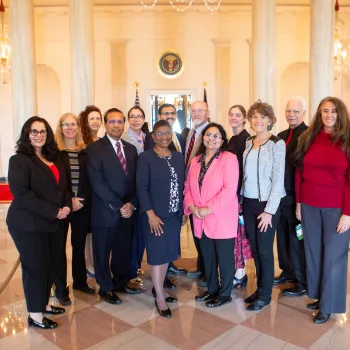 group of people standing inside white house including Dr. Eugenia Paulus