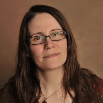 woman smiling wearing glasses