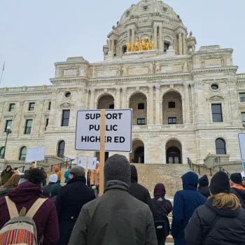 a large group of advocates standing outside the capital building 