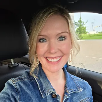 woman smiling sitting in a car